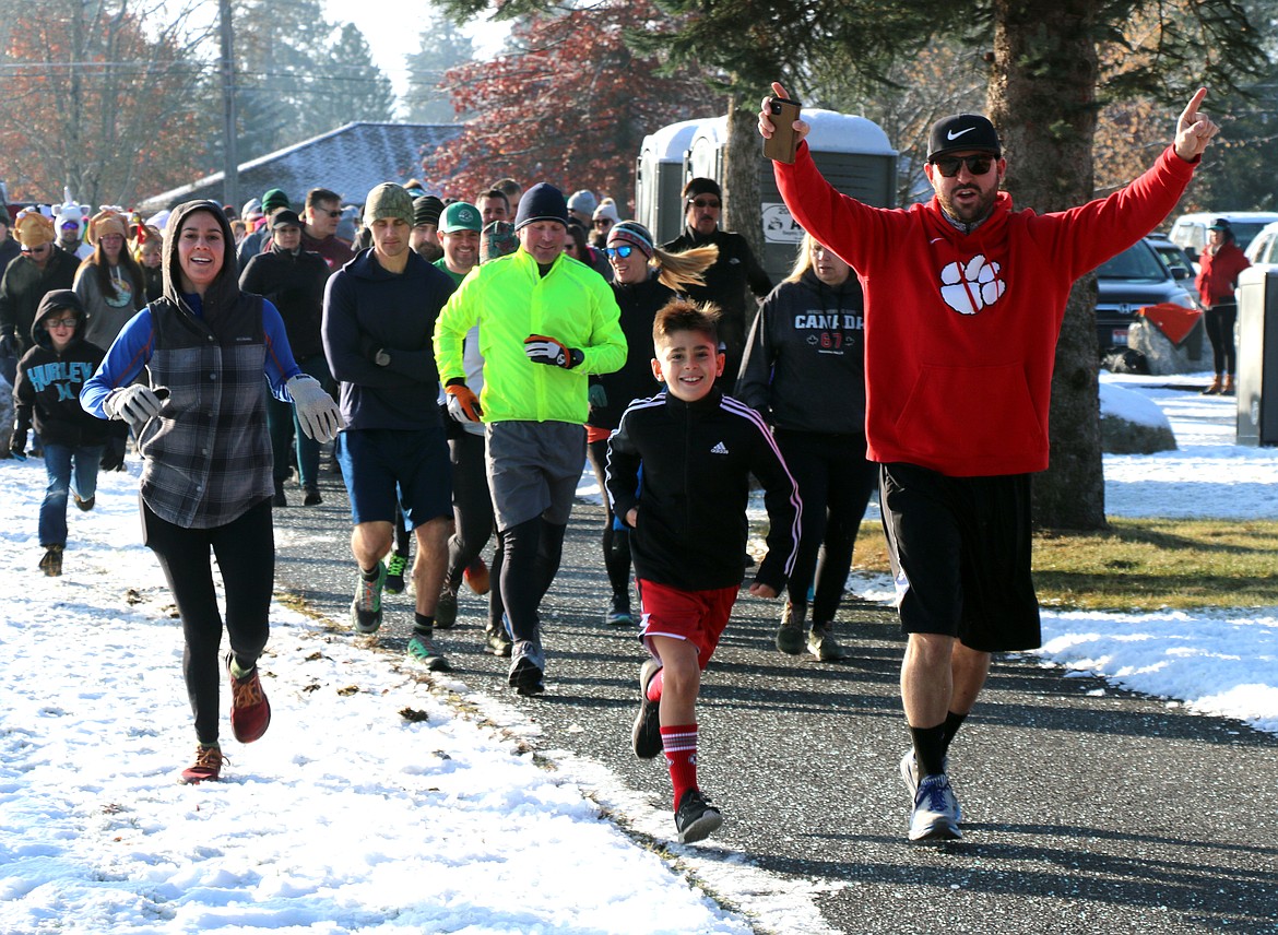 Turkey Trot participants celebrate the start of the annual fun run/walk and benefit for the Bonner Community Food Bank. Held on Thanksgiving morning, an estimated 250 people turned out for the annual walk/run and benefit for the Bonner Community Food Bank.