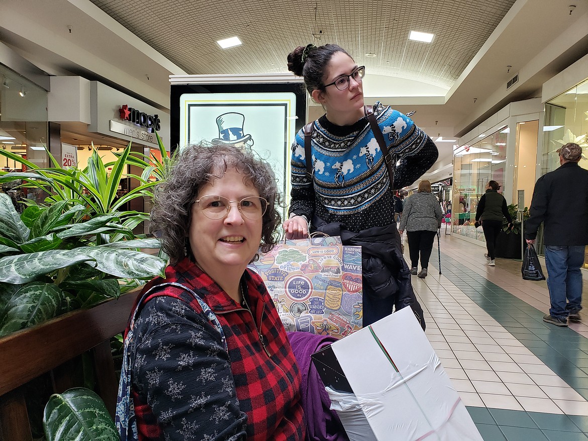 Susan Segsworth, left, gathers her new treasures on a Silver Lake Mall bench after spending the morning finding the best Black Friday deals with Ana Segsworth.