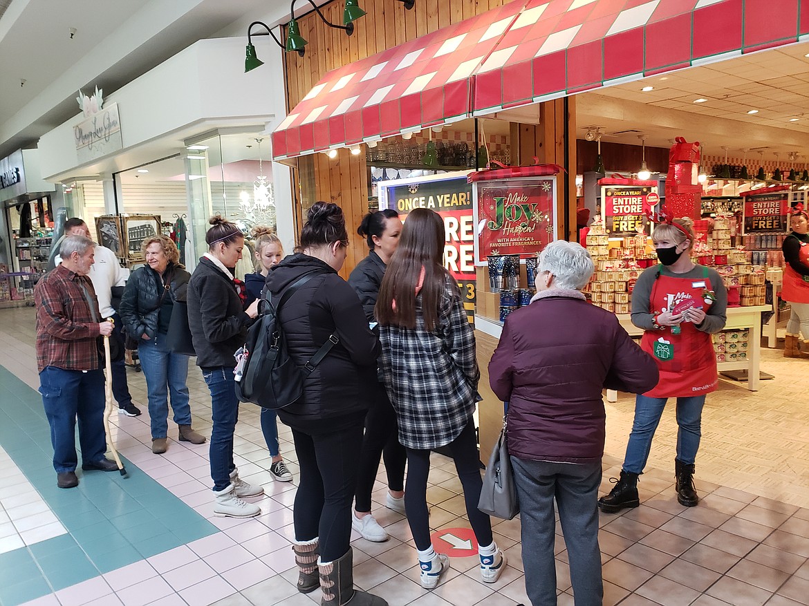 Makenna Lindhurst conducts crowd control as Bath and Body Works in the Silver Lake Mall fills to capacity on Black Friday. Customers line up outside the store for once a year deals on gifts for the family, like buy-three-get-three-free, or 20% off in-store purchases.