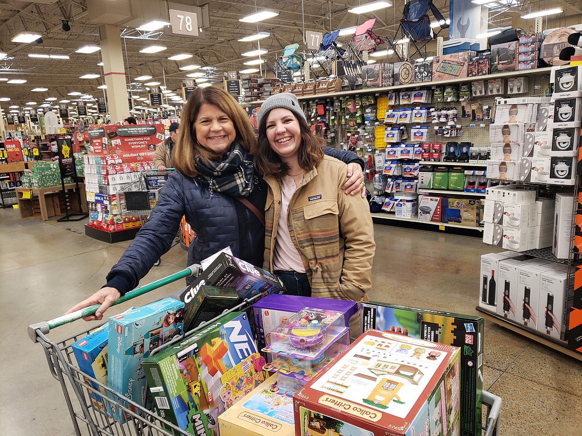 Candy Taranto, left, and Hailey Robb pile their cart with games and toys for the kids and grandkids at the Fred Meyer in Coeur d'Alene. The buy-one-get-one-free deal on games and the 40% sale on Legos made Fred Meyer their one-stop shop on Black Friday.