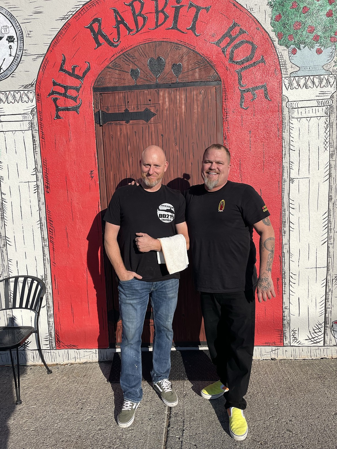 Rick Biery, owner of Rick’s Eatery and Entertainment, and Paul Carney, owner of EDUBS C/S, take a break from serving Thanksgiving meals and pose at the side entrance to Rick’s.