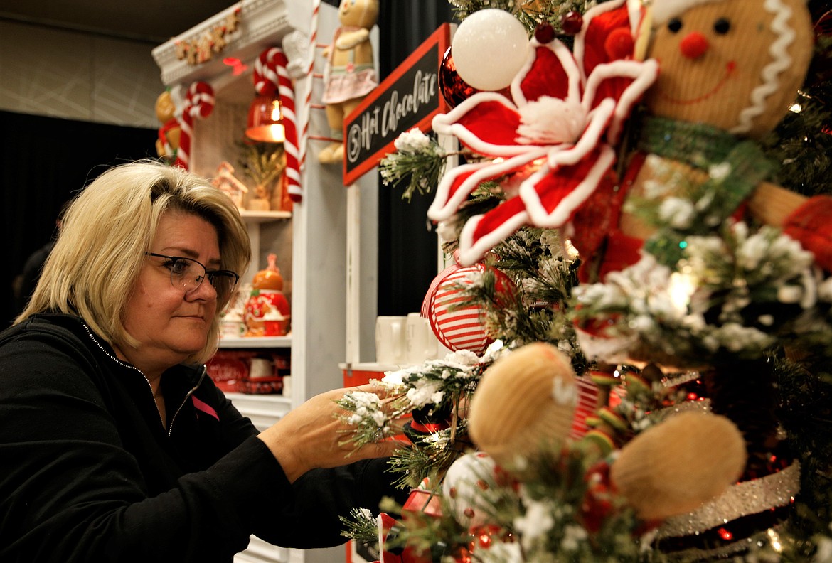 Brandy Read decorates the Mountain West Bank tree for the Festival of Trees on Friday at The Coeur d'Alene Resort.