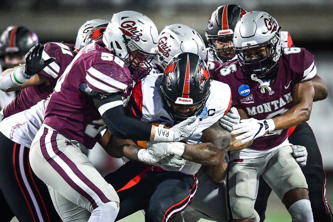 Grizzlies defenders Patrick O'Connell (58) and Justin Ford (6) stop a run by Southeast Missouri State running back Geno Hess (6) in the third quarter of an FCS playoff game at Washington-Grizzly Stadium on Saturday, Nov. 26. (Casey Kreider/Daily Inter Lake)