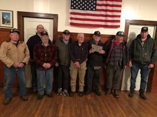Members of the VFW in Superior present Doug Cummings with a plaque commemorating 70 years in Post 6238 for his service and fellowship at their headquarters inside the Mason Lodge. (Monte Turner/Mineral Independent)
