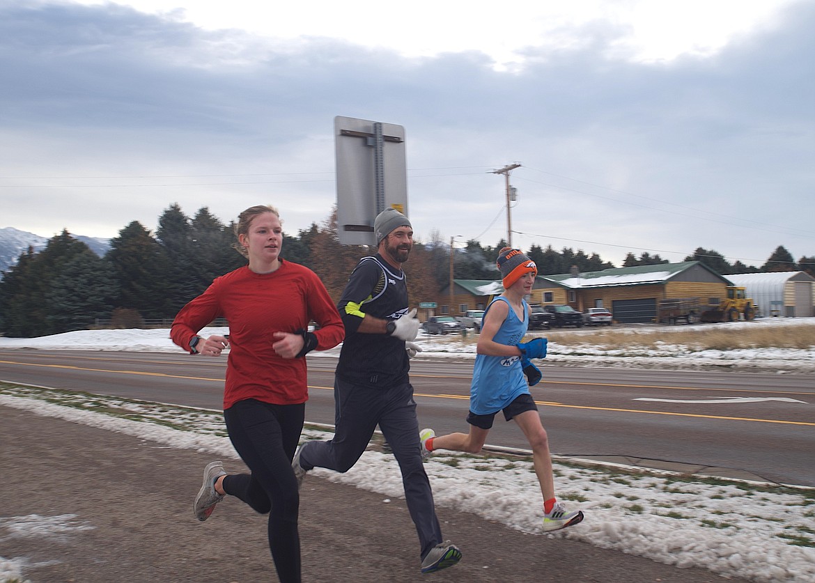 A trio of runners race to the Turkey Trot finish line last Thursday. (Daniel Cadigan)