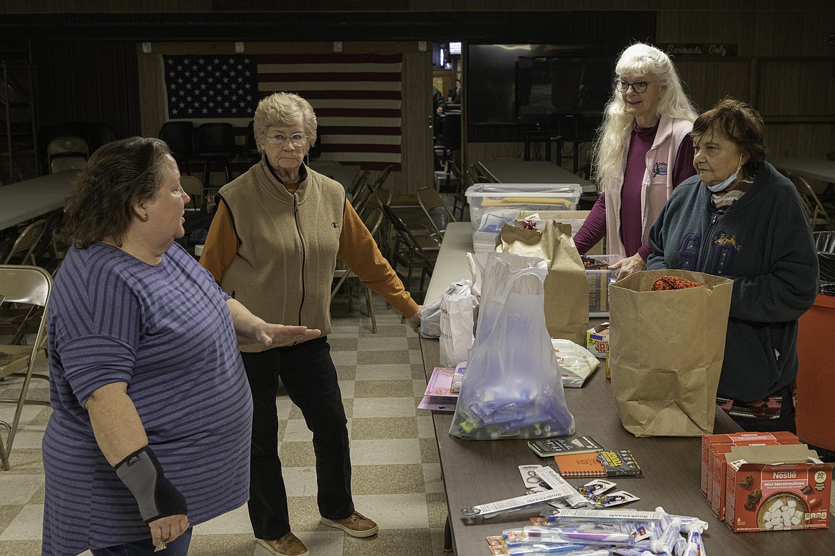Volunteers fill care packages to be sent to troops for the holiday season. (Tracy Scott/Valley Press)