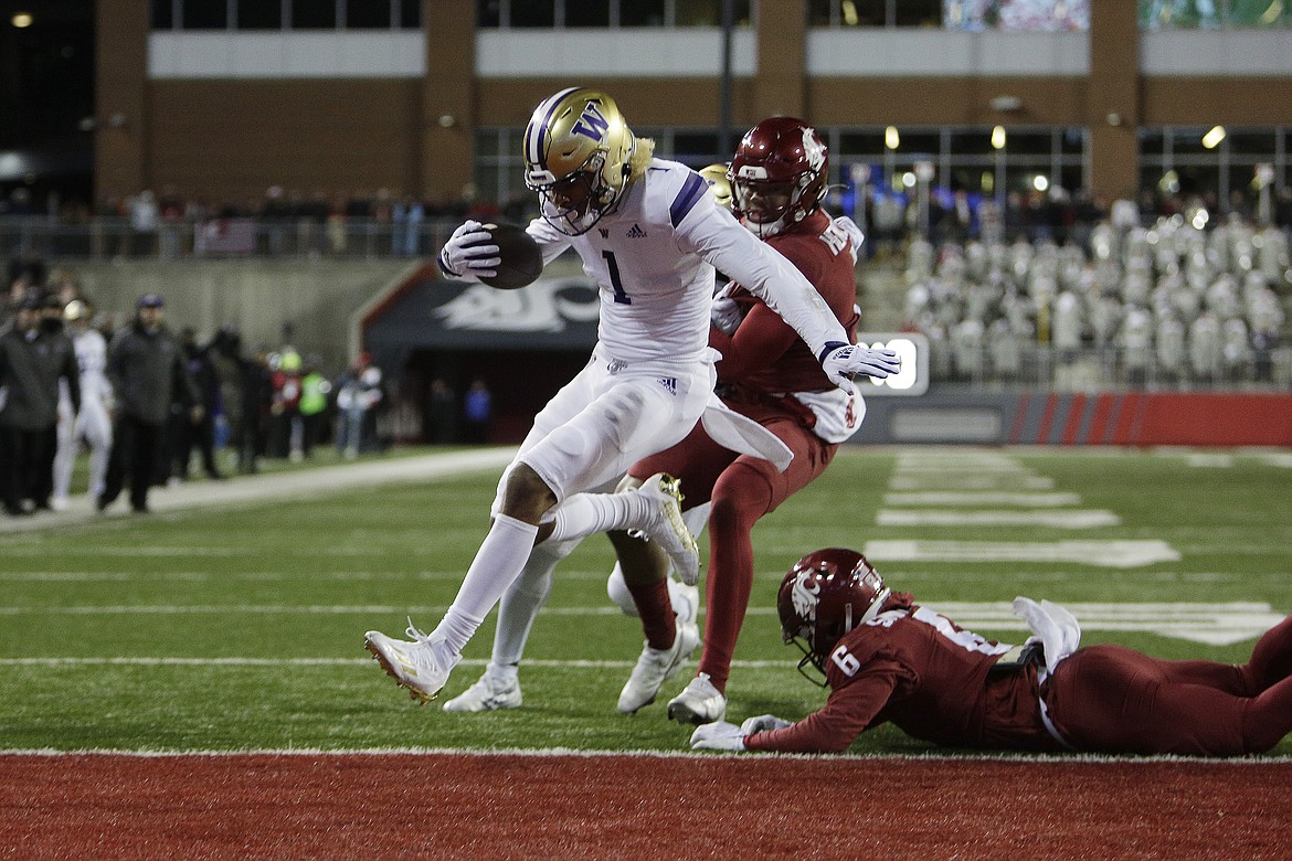 UW receiver Rome Odunze runs into the end zone in Saturday’s Apple Cup. Receivers caught 25 passes for 485 yards and three touchdowns against the WSU secondary.