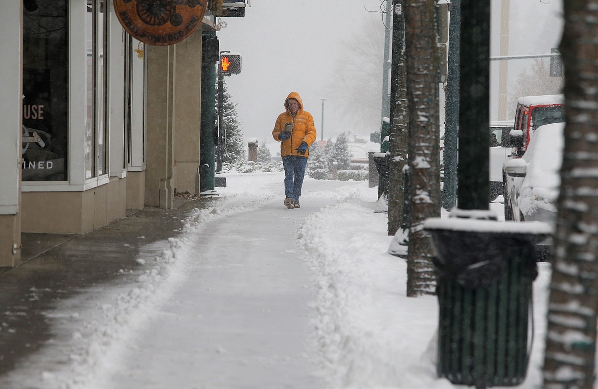 Steve Franey walks on Sherman Avenue during  Monday's snowfall. He said he enjoys getting out for walks in all kinds of weather.