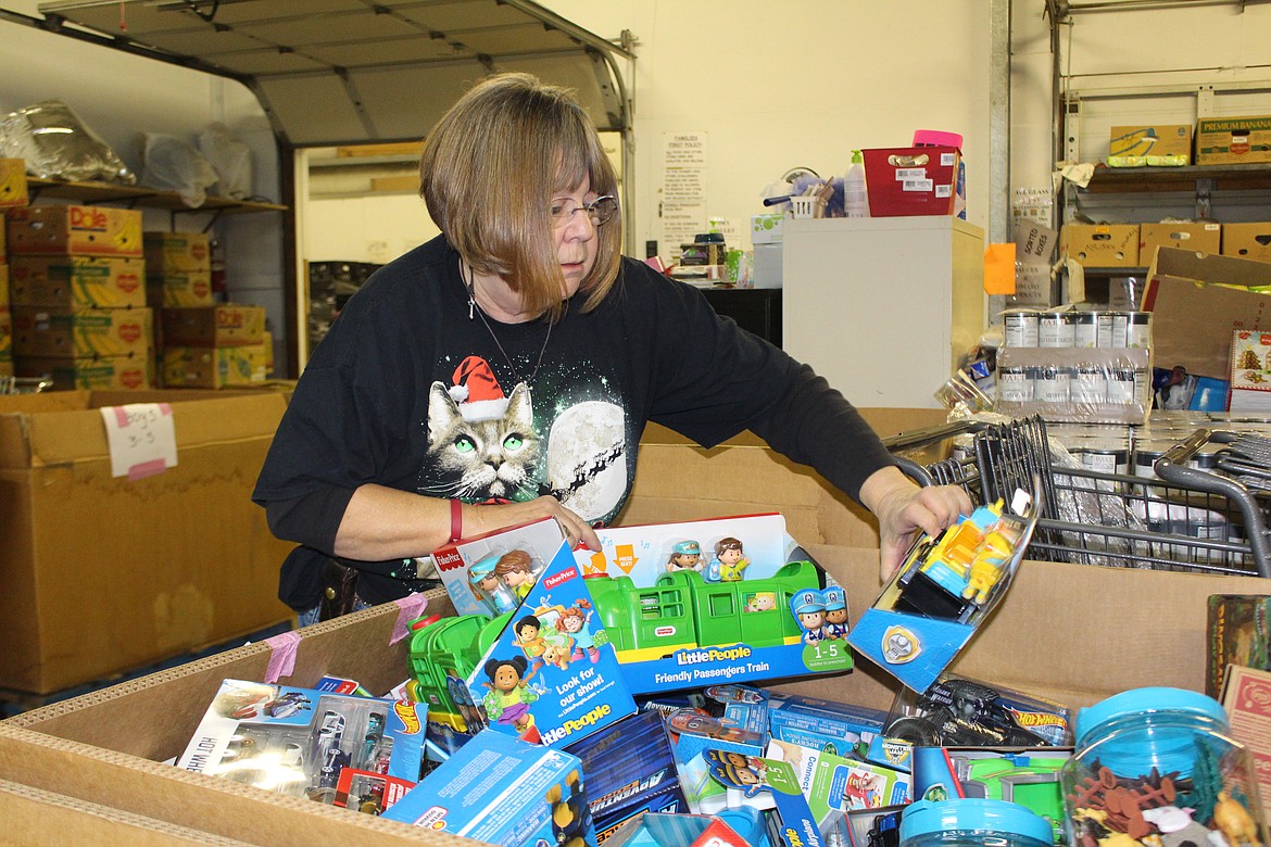Sandi Casebolt sorts toys donated for Operation Friendship, the Moses Lake Food Bank’s annual toy distribution, in 2018. The food bank is accepting donations for this year’s giveaway, as are the Ephrata Food Bank and other agencies in Basin communities.