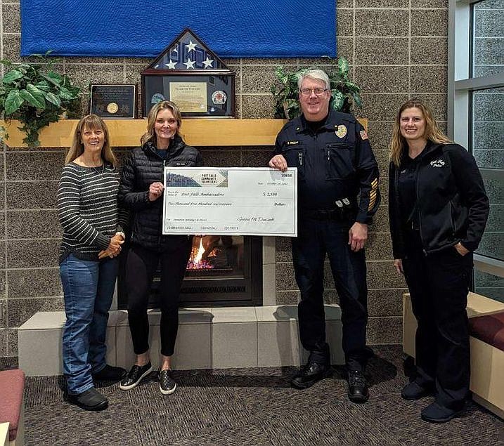 The Post Falls Community Volunteers this month donated $10,000 to area causes, including $2,500 to the Post Falls Police Department's Post Falls Ambassadors program. From left: Lisa Houston and Geena Duczek, Post Falls Community
Volunteers; and Chief Greg McLean and Lori Flood, Post Falls Police Department.