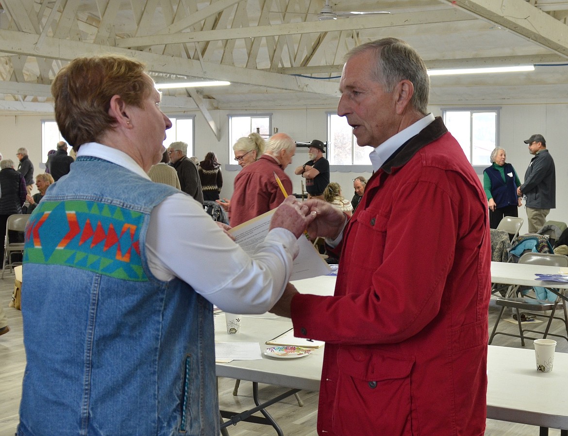 Former Montana Governor Mark Racicot visits with Lynn Kelly of Polson during a Democratic confab in Plains Nov. 20. (Kristi Niemeyer/Lake County Leader)