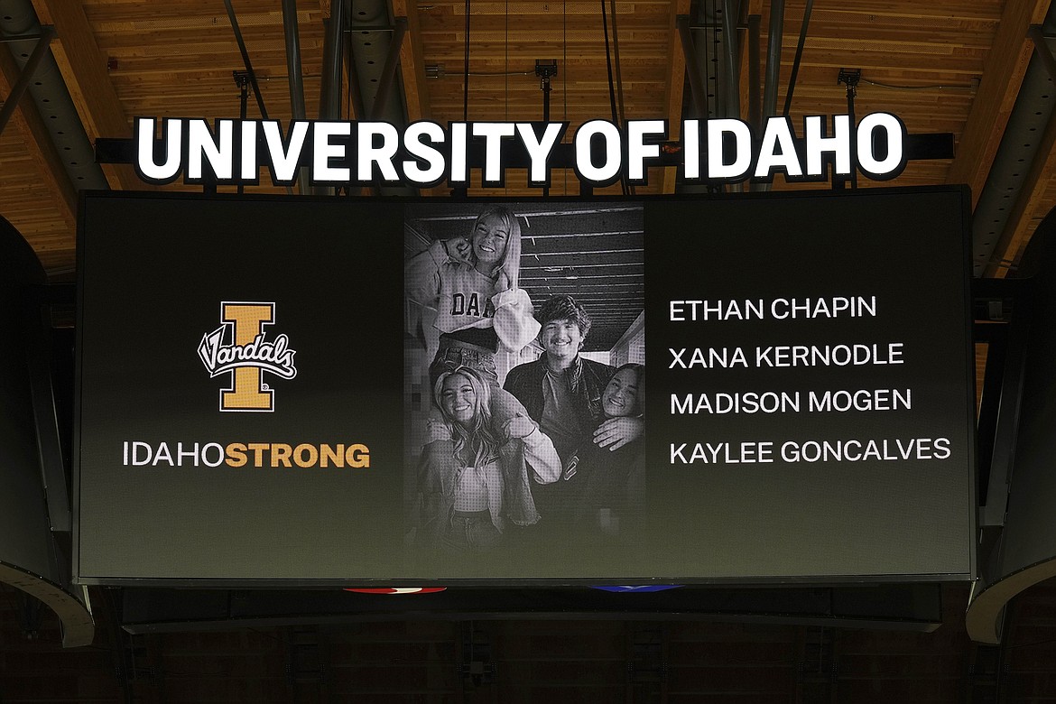 FILE - A photo and the names of four University of Idaho students who were killed over the weekend at a residence near campus are displayed during a moment of silence, Nov. 16, 2022, before an NCAA college basketball game in Moscow, Idaho. The Moscow Police Department has yet to name a person of interest in the stabbing deaths of the students.