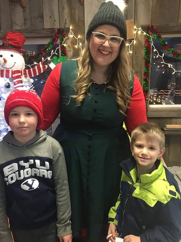 One of Santa's elves poses with a pair of visitors during a past Santa's Village event at Jake's Landing in Porthill.