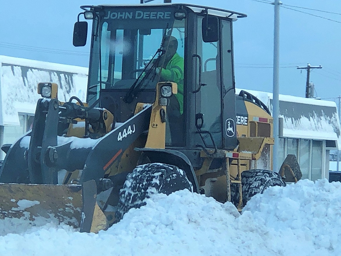 City of Moses Lake employee Scott Allsbrook removes snow from Third Avenue Wednesday morning. Most cities in the Basin have a plan for snow removal that includes which streets are a priority and where snow can be stored while it waits for spring.