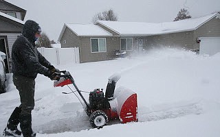 Greg Clarine on Wednesday pushes through thick, heavy snow with his snowblower as a snowstorm blankets Post Falls.