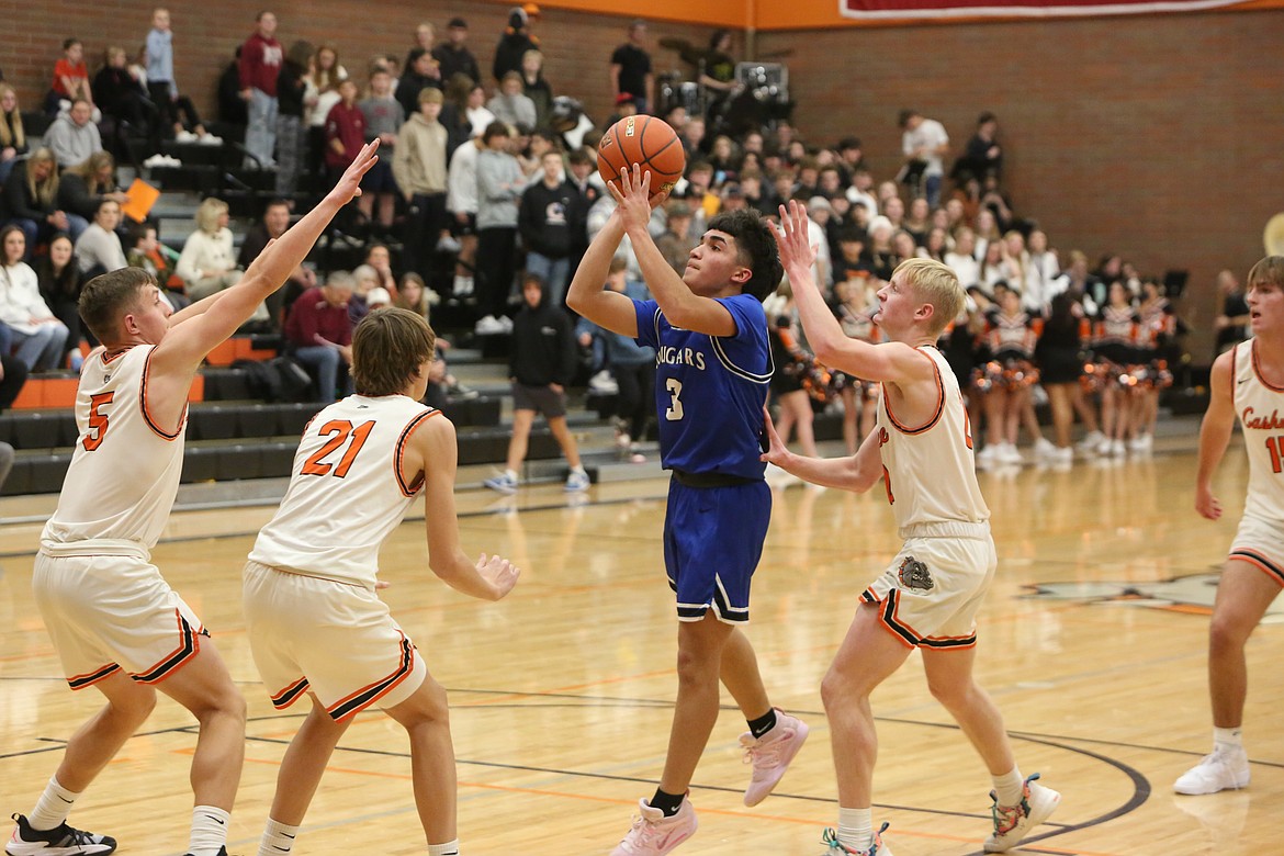 Warden sophomore Anthony Gutierrez drives into the paint against three Cashmere defenders.