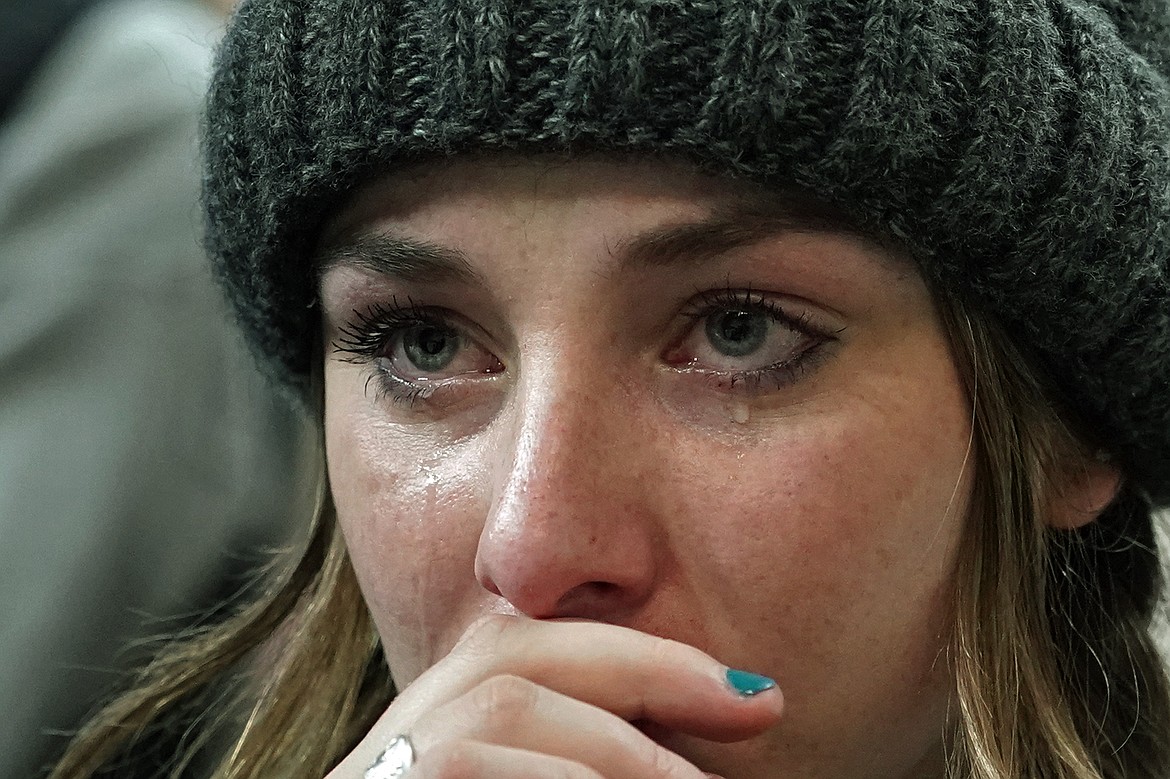 A person attending a Moscow, Idaho, vigil Wednesday for the four University of Idaho students who were killed on Nov. 13 cries as she listens to family members talk about the victims.