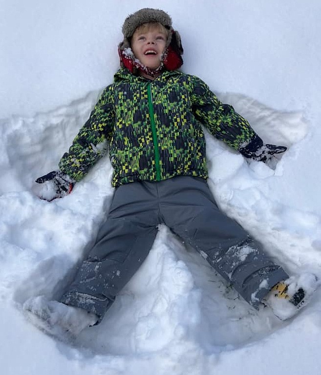 Almost-5-year-old Mason Helvy of Moses Lake had a ball in the snow Wednesday making a snow angel.