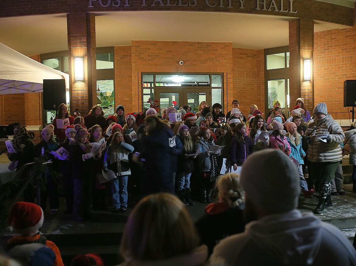 Students in the Ponderosa and Prairie View elementary special choirs perform holiday songs Friday evening in front of Post Falls City Hall.