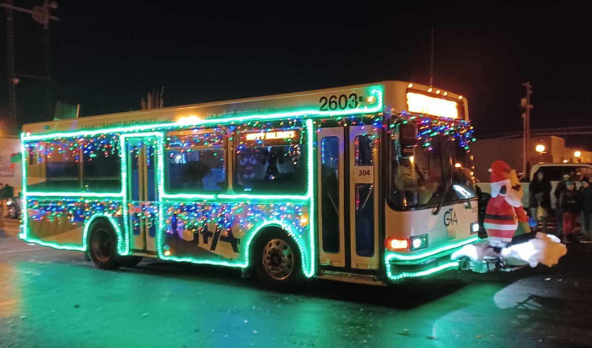 Not all the parade entrants at the Ag Parade were farm machinery. This Grant Transit Authority bus rolled proudly down Third Avenue with Santa Claus leading the way and Frosty the Snowman riding on the back.