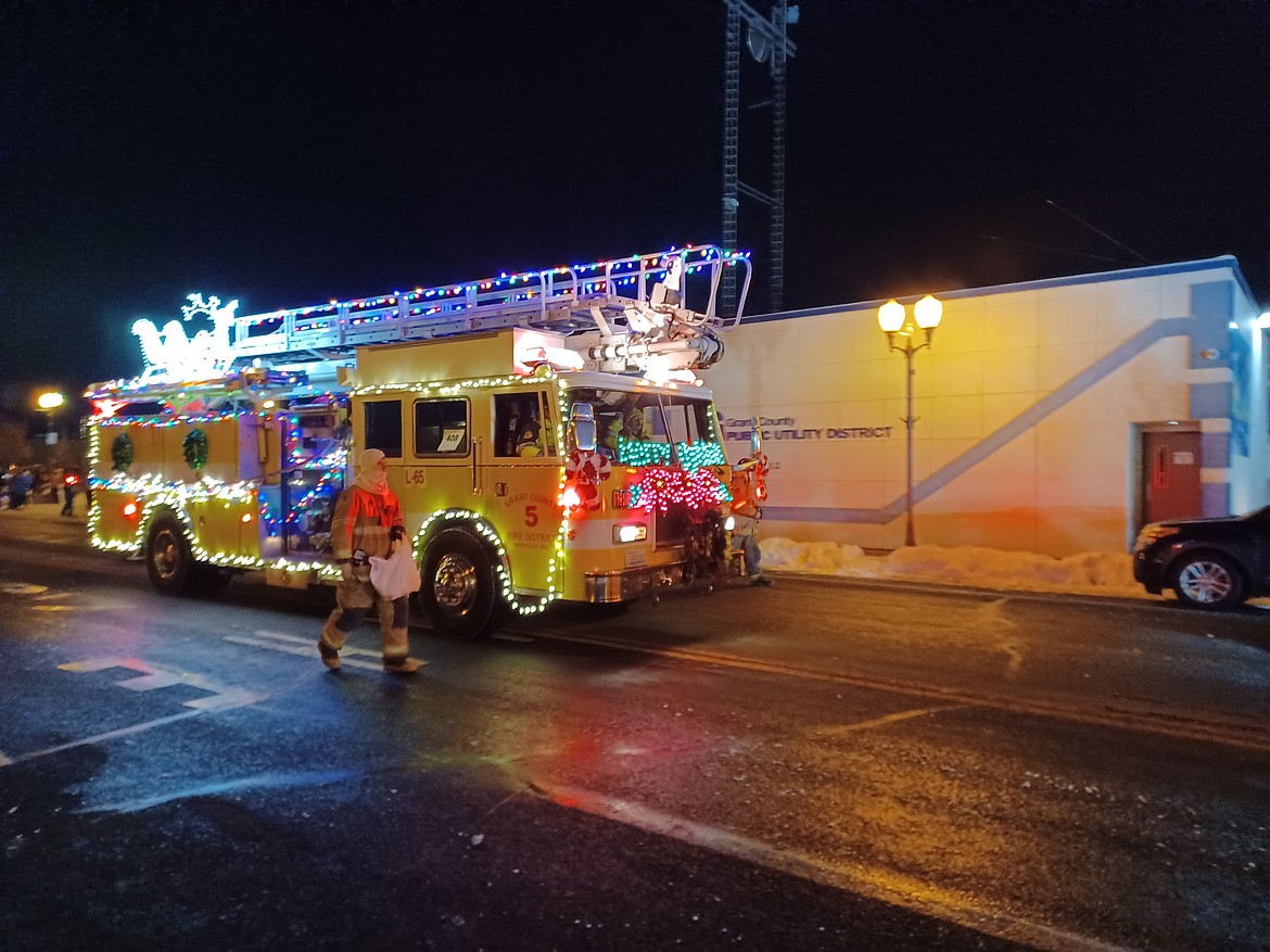 A bedecked fire truck rolls down Third Avenue in Moses Lake as part of the Ag Appreciation Parade Friday.