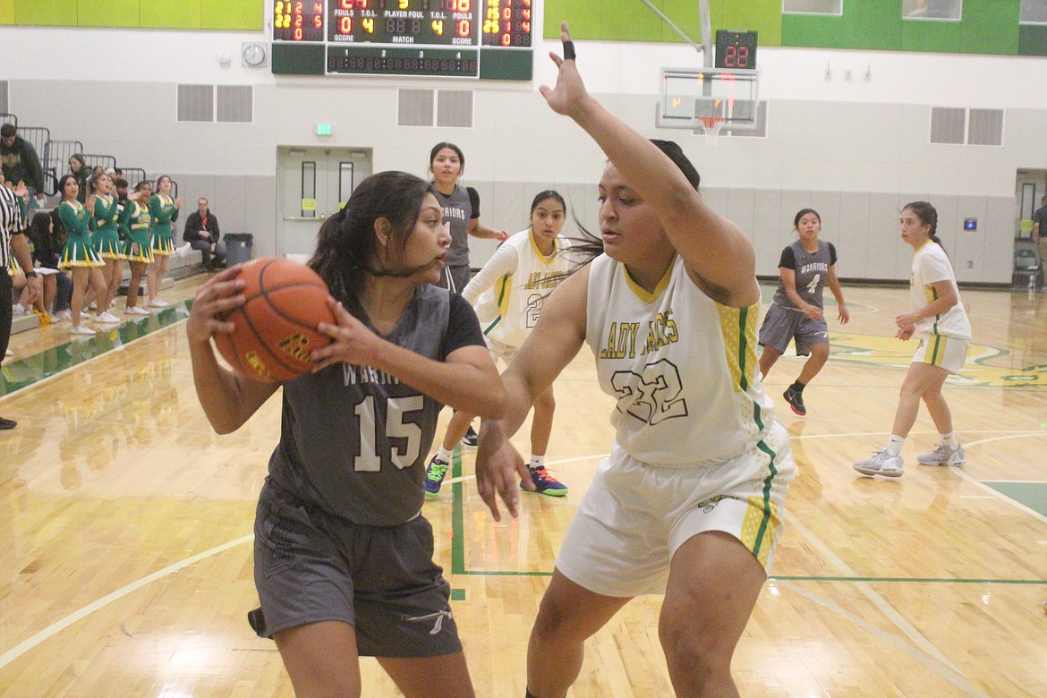 Wahluke’s Kylee Tirado (15) looks to pass the ball against Quincy’s Ruth Flores (22).