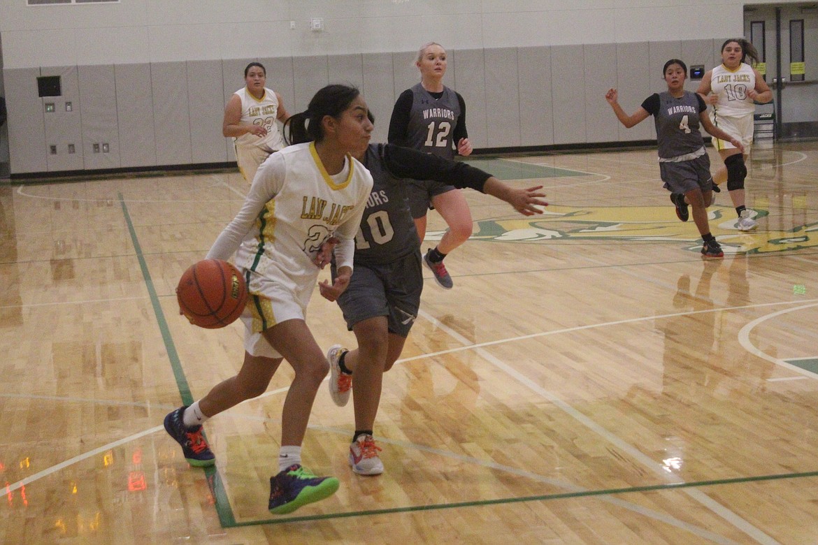 Chloe Medina, Quincy, makes a move around Wahluke’s Brianna Herrera.