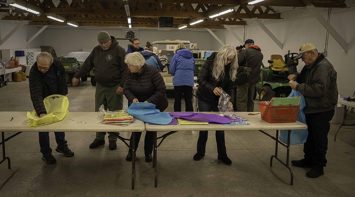Cancer Network of Sanders County volunteers assemble lanterns in the Sanders County Fairgrounds Ag Building. (Tracy Scott/Valley Press)