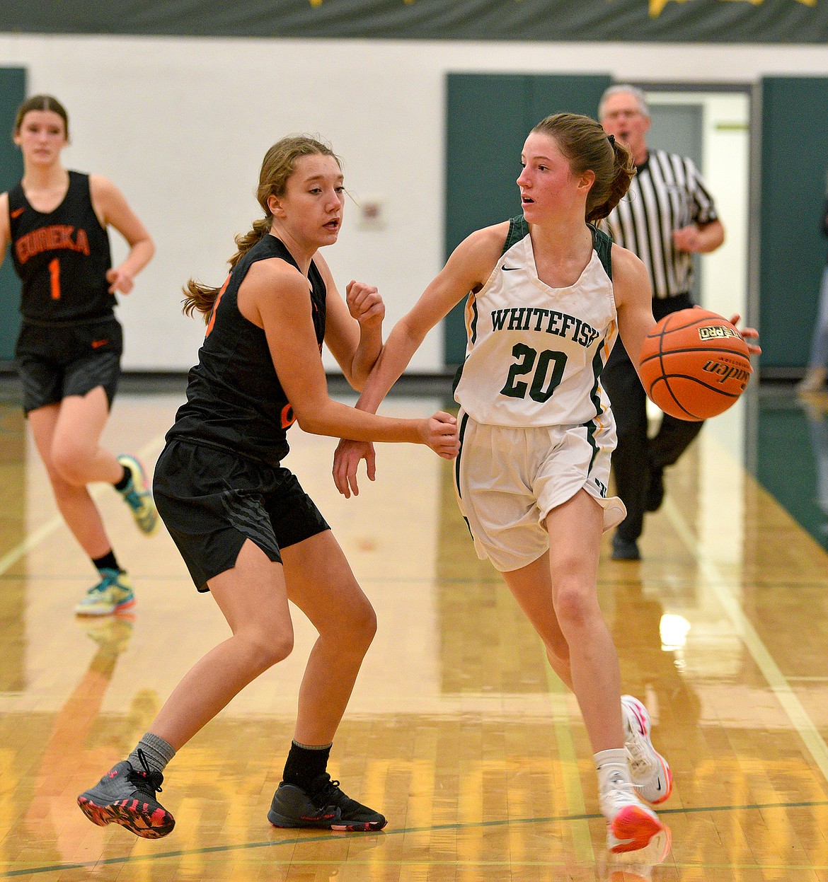 Whitefish junior Hailey Ells takes the ball down the court during a game against Eureka on Friday in Whitefish. (Whitney England/Whitefish Pilot)