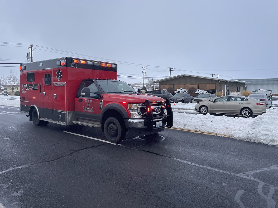 A Moses Lake Fire Department ambulance roars down Third Avenue on a call on Tuesday.