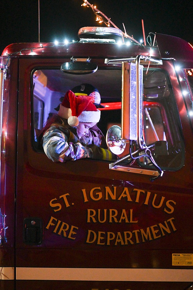 Santa's helper waits for the Parade of Lights to get underway in St. Ignatius Saturday night. (Photo by Christa Umphrey)