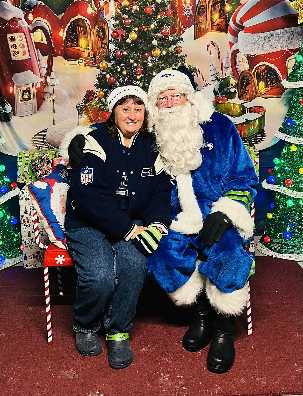 Whether in red or blue, Santa brings joy to those around him. Who says you can't support your favorite team on the job?