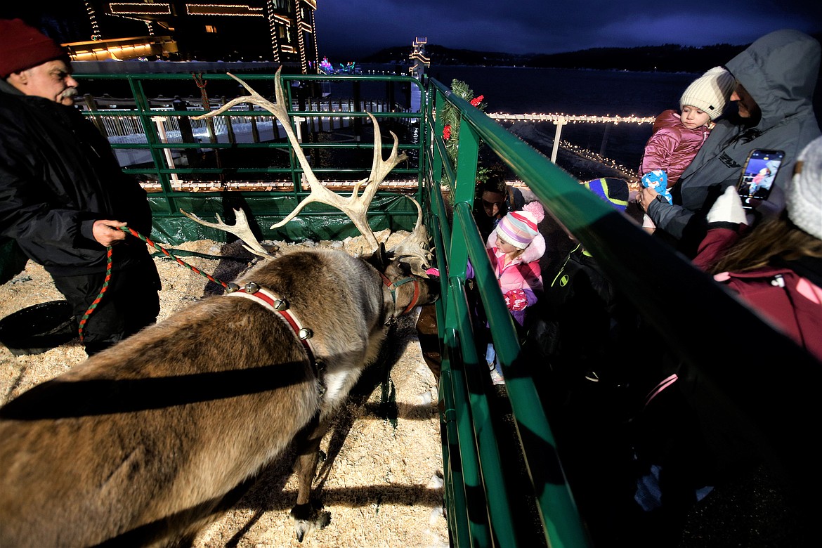 Kids and adults visit with reindeer at the Reindeer Express at The Coeur d'Alene Resort on Tuesday.