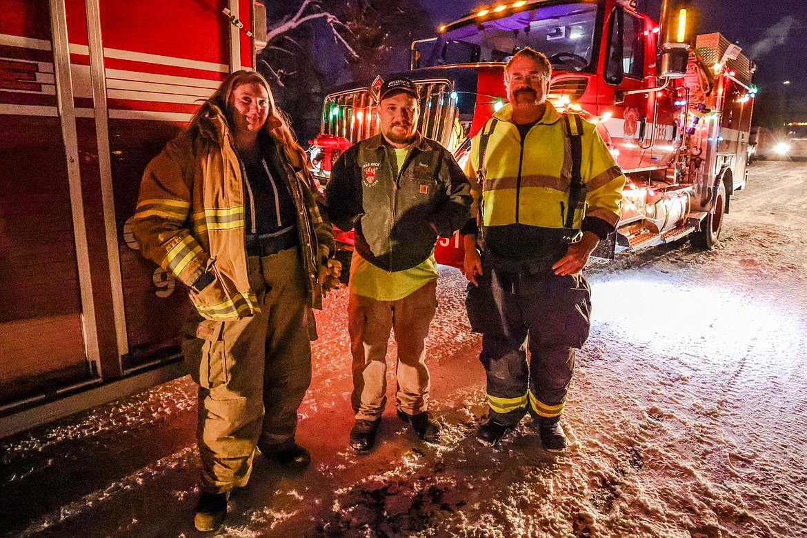 Bad Rock Fire crew members, from left, Heather Williams, Travis Cannon and Mark Williams at the Night of Lights Parade on Friday. (JP Edge photo)