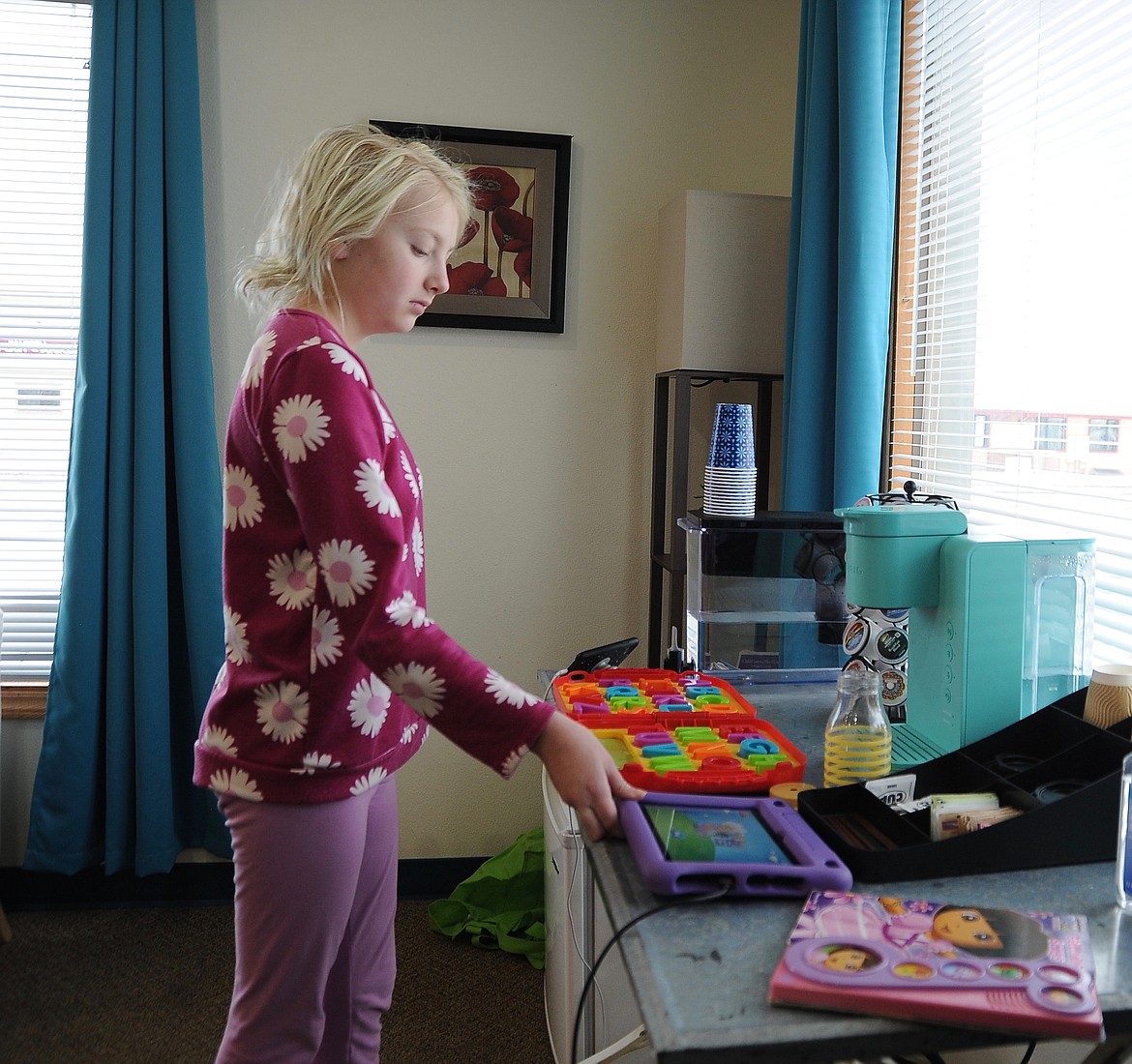 Nurtured Growth Learning Center student Rylee listens to music and organizes her space at the school Wednesday, Dec. 7, 2022. Her mother April Schottelkorb started the school to serve children with a variety of developmental, sensory and learning needs. (Hilary Matheson/Daily Inter Lake)