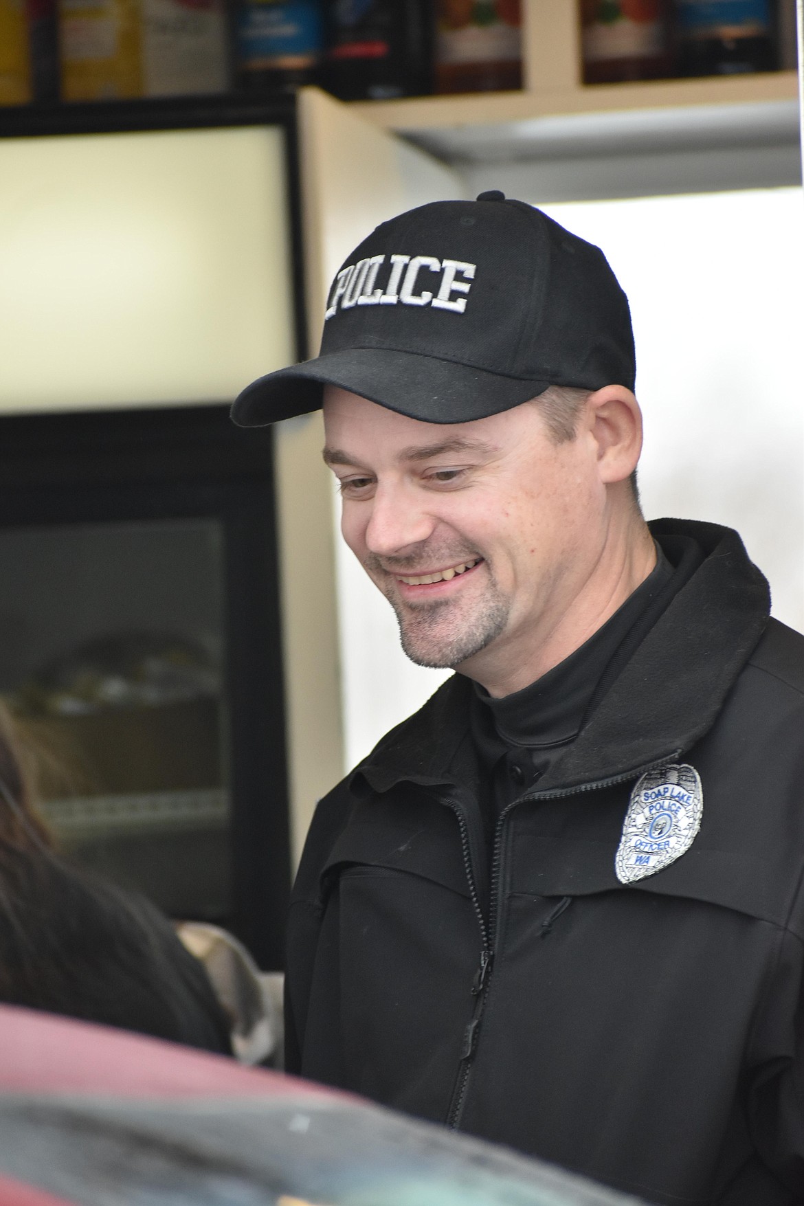 Soap Lake Police Officer Robert Geates smiled as he chatted with customers and took their orders.