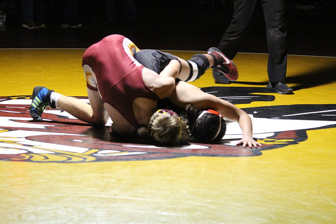 Dayton Regan (maroon) Moses Lake, works in close quarters against Sunnyside’s Mason Mendoza in Wednesday’s dual meet.