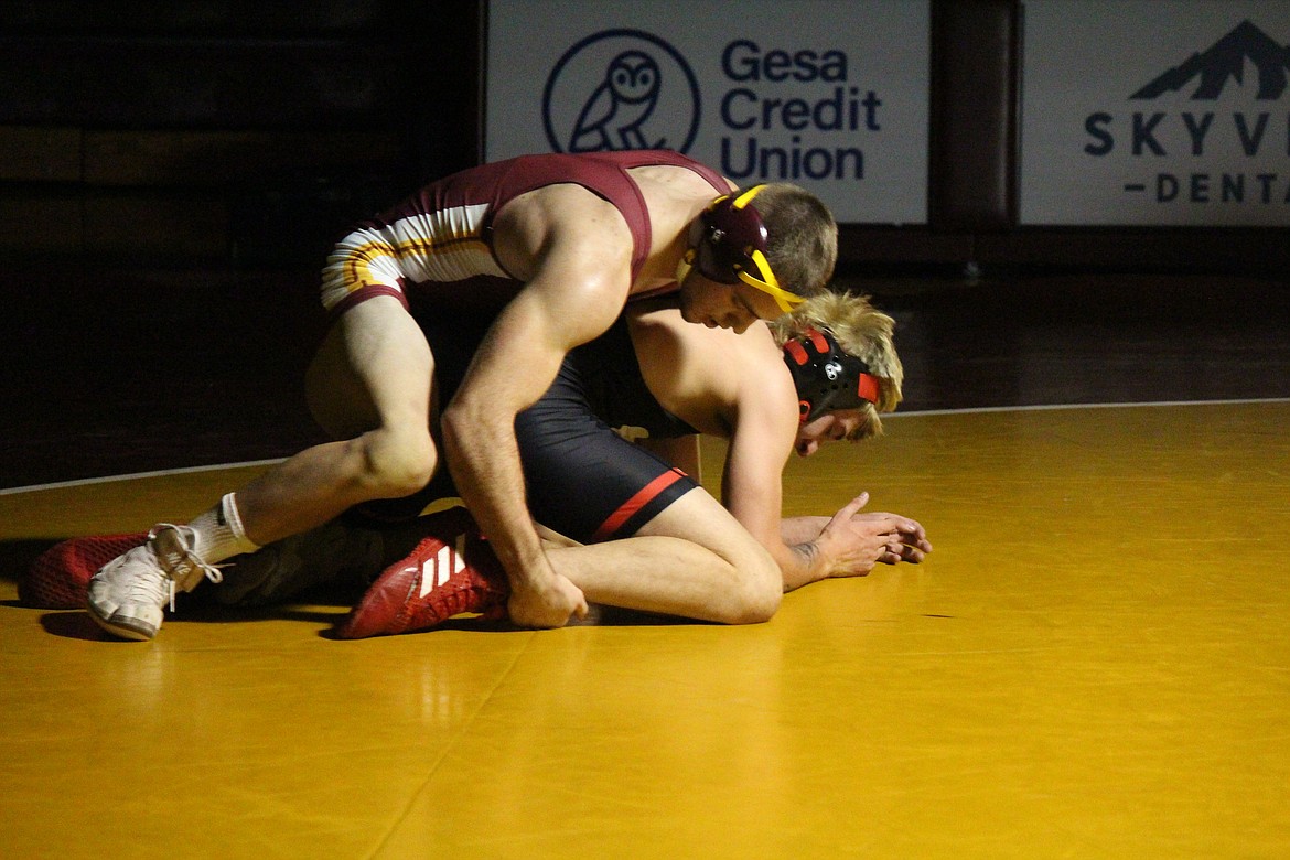 Moses Lake’s Brock Clark (top) works against Sunnyside’s John Rendon in the Mavericks’ dual meet Wednesday.