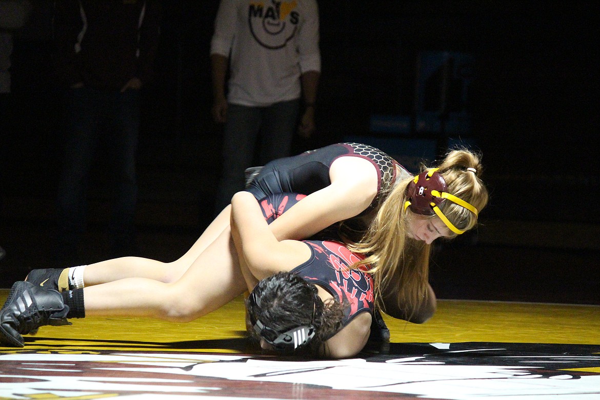 Reese Prescott (black) of Moses Lake works to turn Jocelyn Herrera of Sunnyside in Moses Lake’s dual meet with Sunnyside Wednesday.