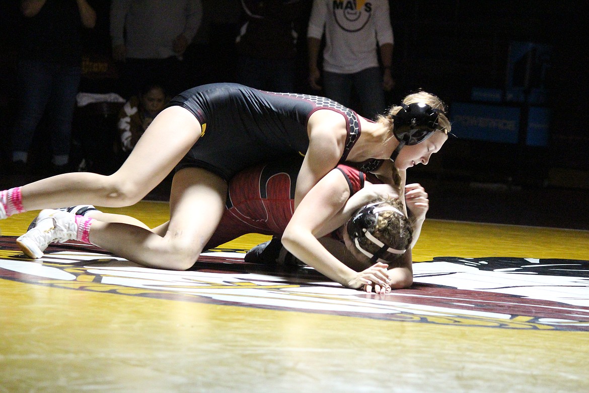 Moses Lake’s Kathryn Pugh (black) has a headlock on her opponent in Wednesday’s dual match with Sunnyside.