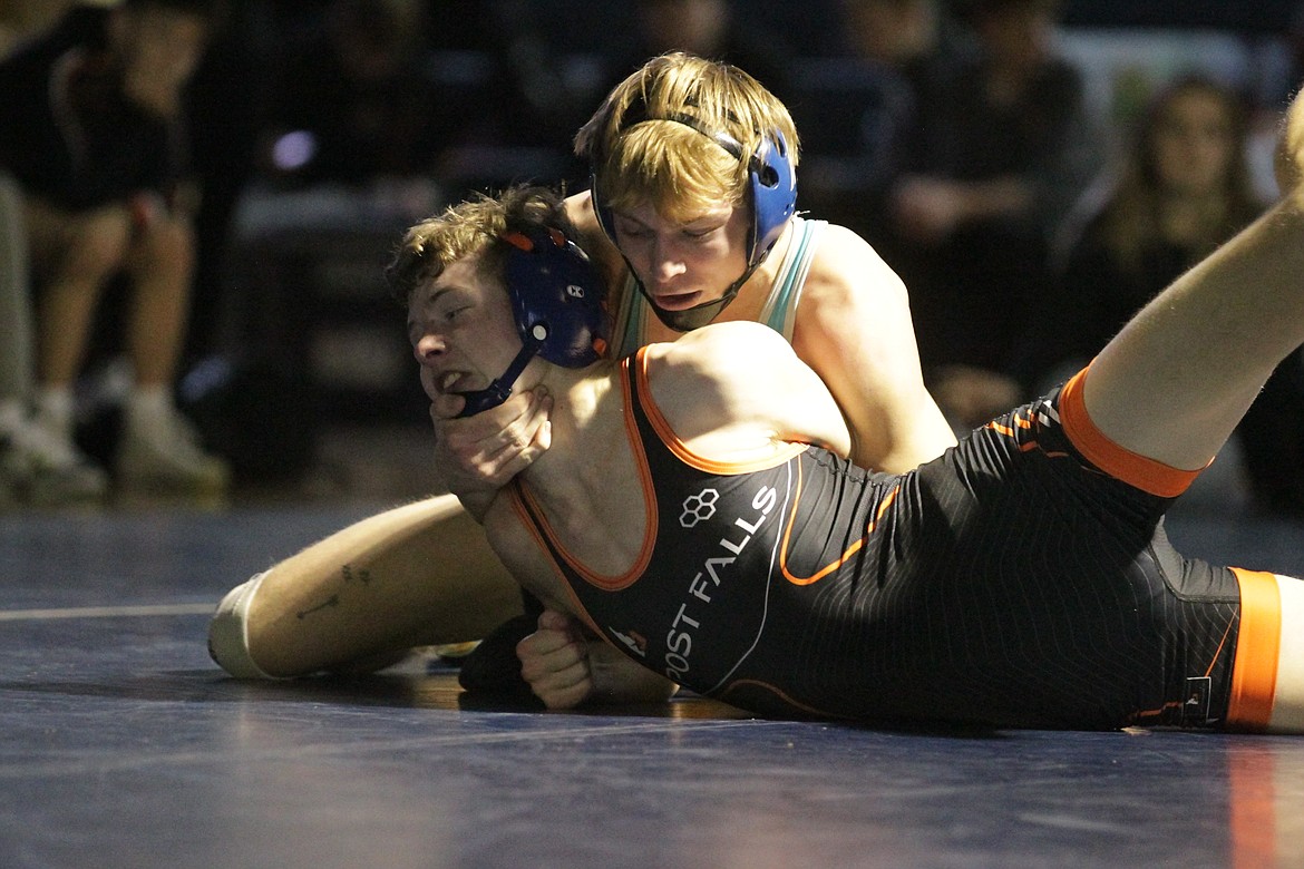 JASON ELLIOTT/Press
Lake City senior Blaine Leonard holds off Post Falls junior Connor McCarroll in a match at 138-pounds at Lake City High on Thursday.