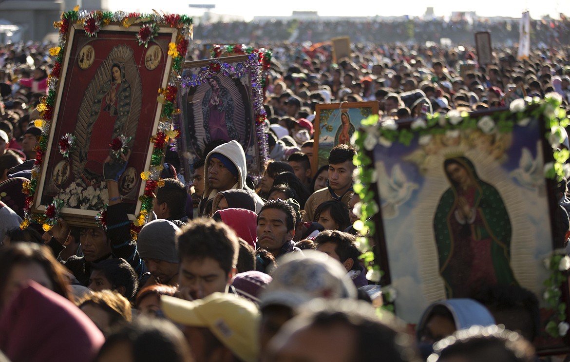 Pilgrims wait their turn to enter the Basilica of Guadalupe, in Mexico City, Dec. 12, 2013. Hundreds of thousands of people from all over the country converge on Mexico's holy Roman Catholic site, many bringing with them images or statues of Mexico's patron saint to be blessed, marking the Virgin's Dec. 12 feast day. (AP Photo/Eduardo Verdugo, File)