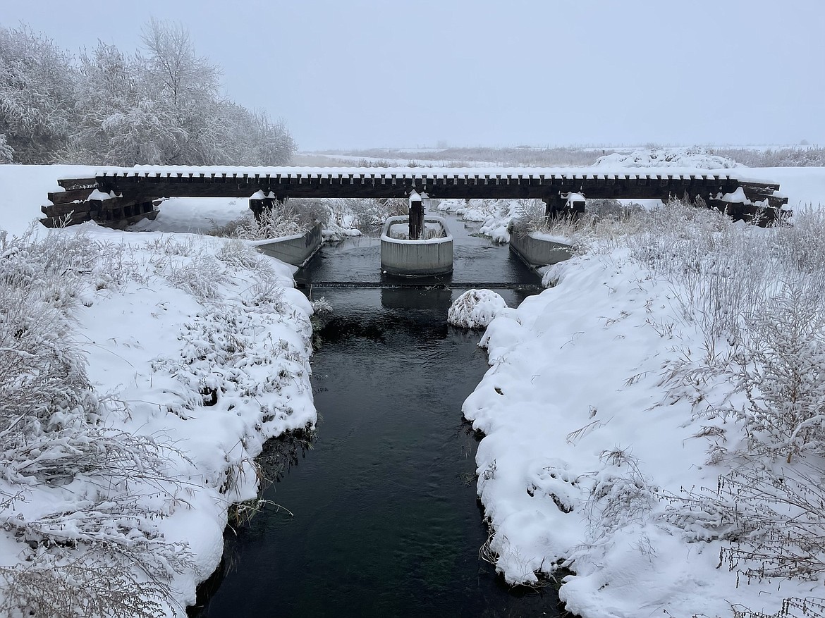 A creek flows underneath a snow-covered Columbia Basin Railroad bridge just south of Moses Lake on Friday morning, just after the latest round of snowfall.