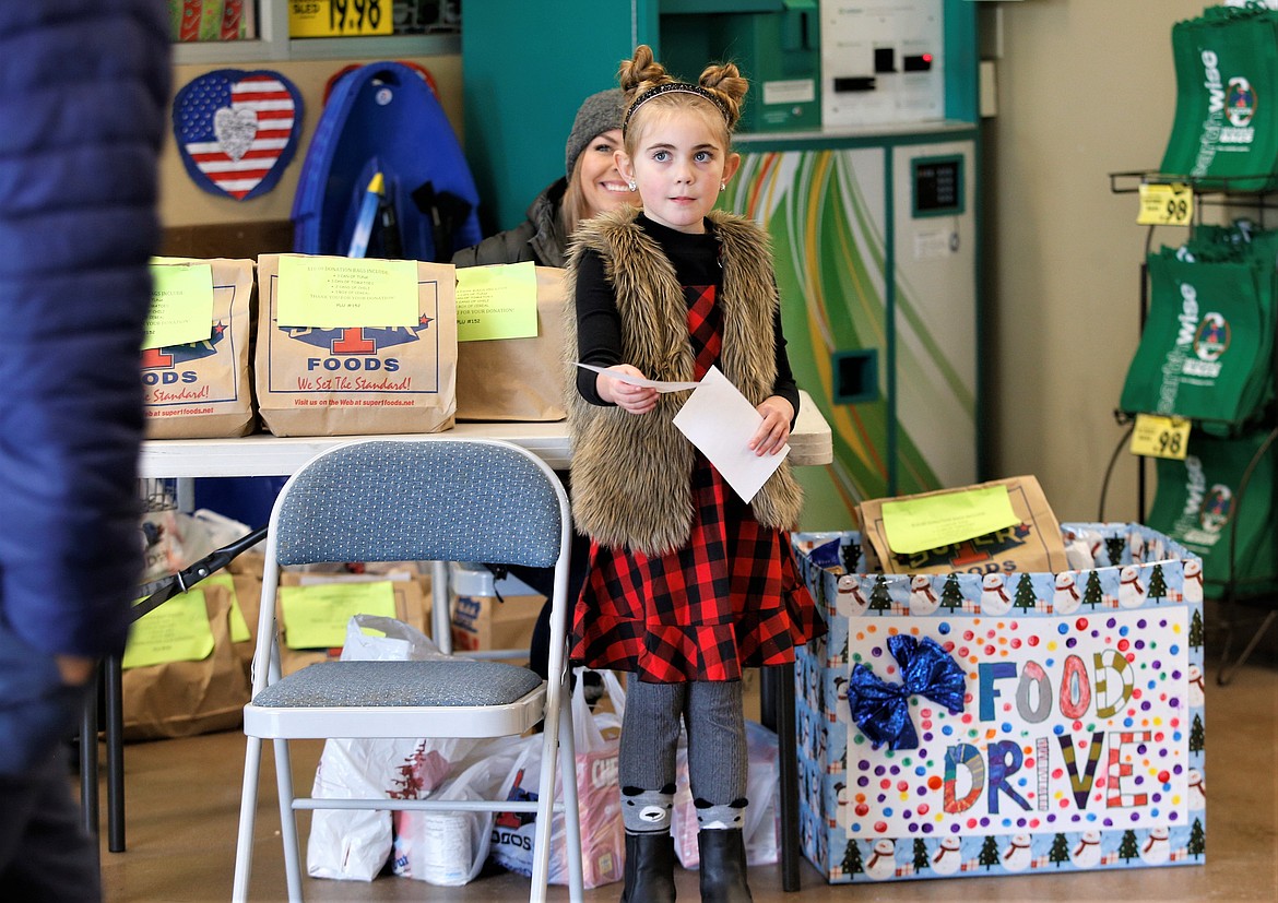 Lola Haycraft holds out her list for items she is collecting for her food drive at Super 1 Foods in Hayden on Saturday.