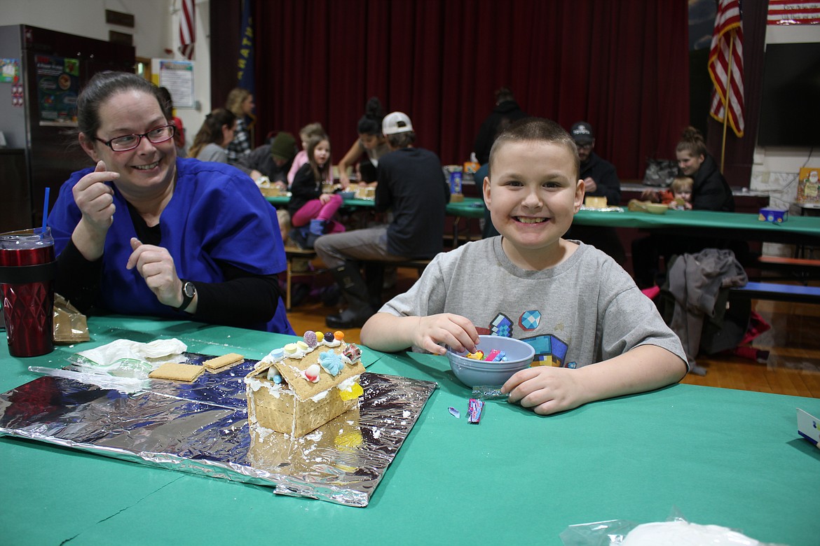 Plenty of smiles were in the Alberton School gymnasium Sunday as the PTSA held a free family gingerbread building event. (Monte Turner/Mineral Independent)