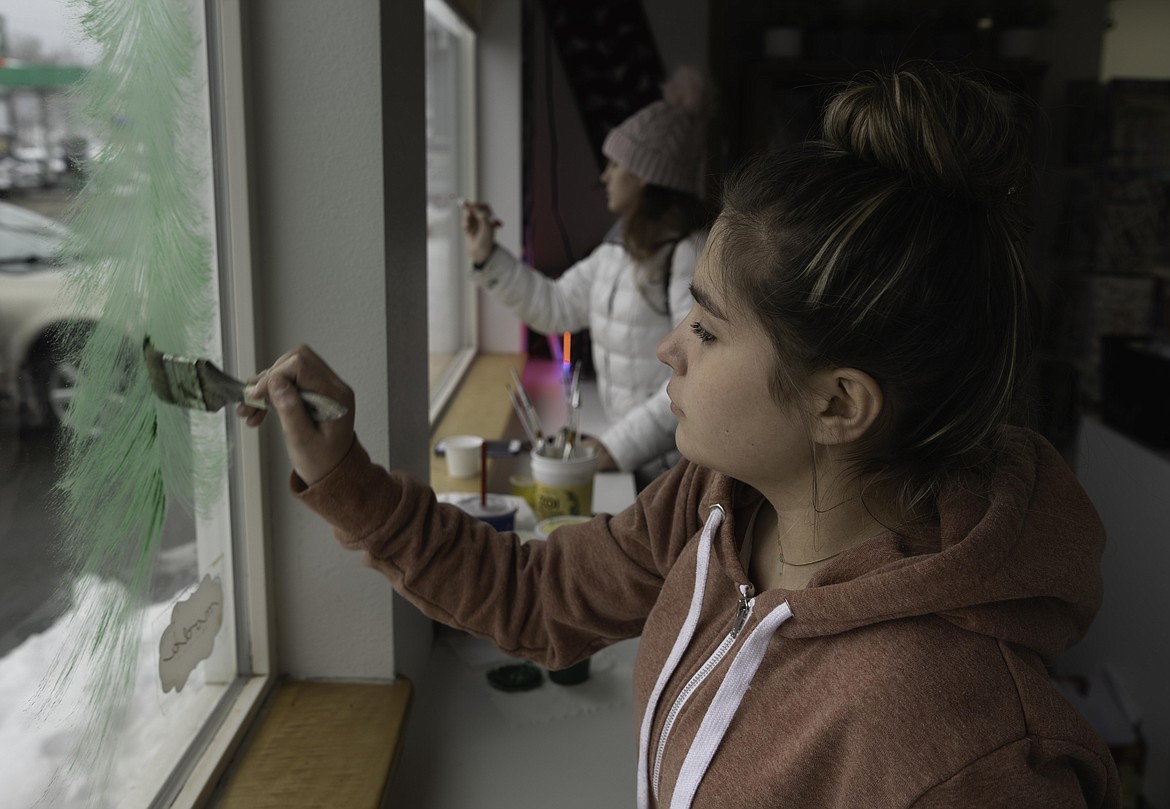 Plains senior Lilly Geenen paints Christmas trees at The Fabric Pixie. (Tracy Scott/Valley Press)