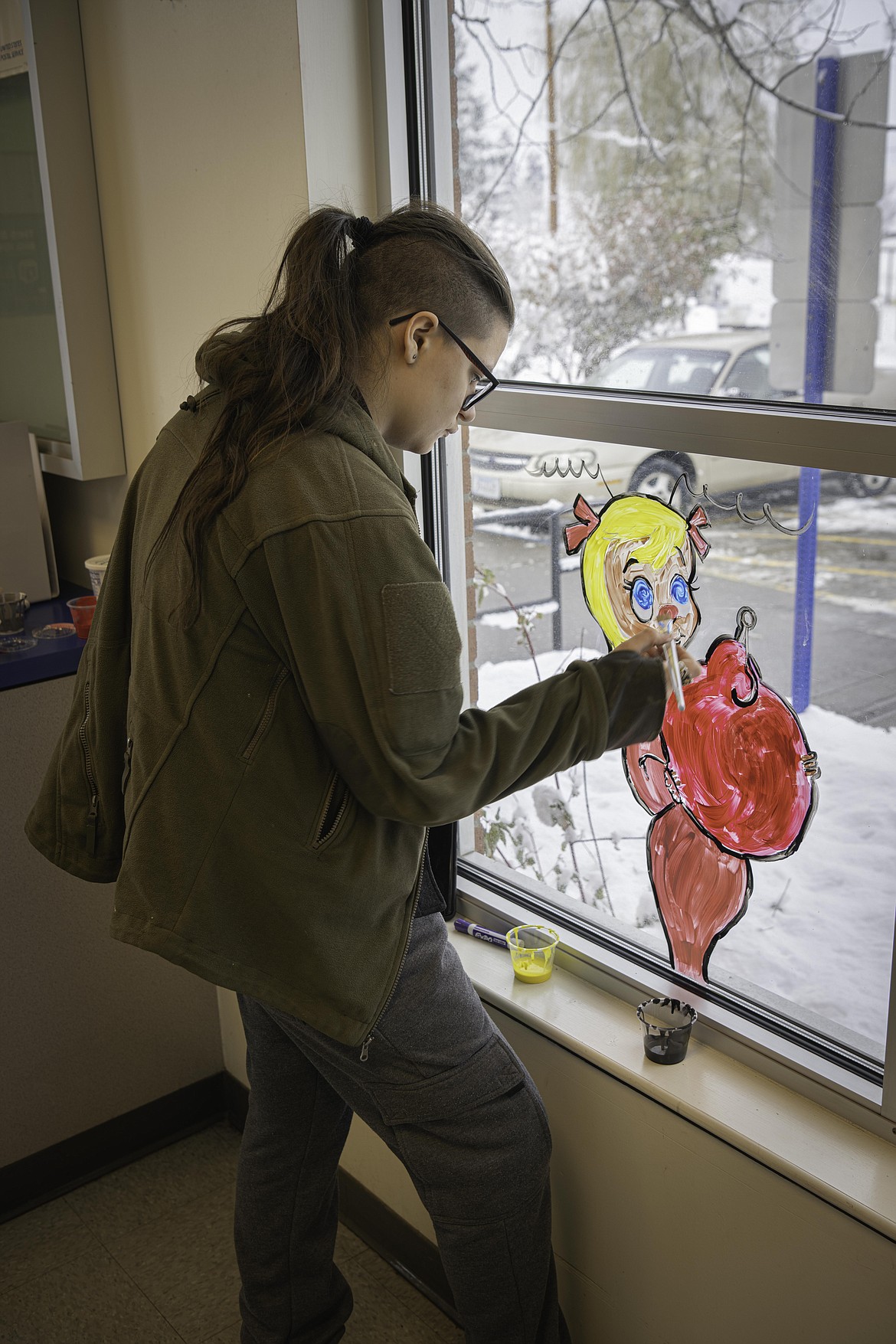 ReBea Privett paints Cindy Lou Who at the Plains Post Office
