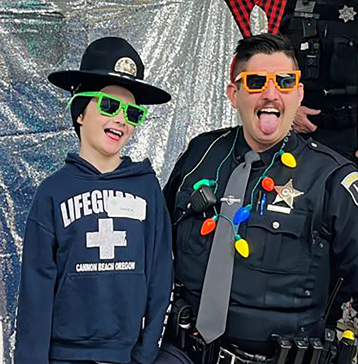 An Idaho State Police trooper and a local youth make faces for the camera at last week's "Shop with a Cop" event.