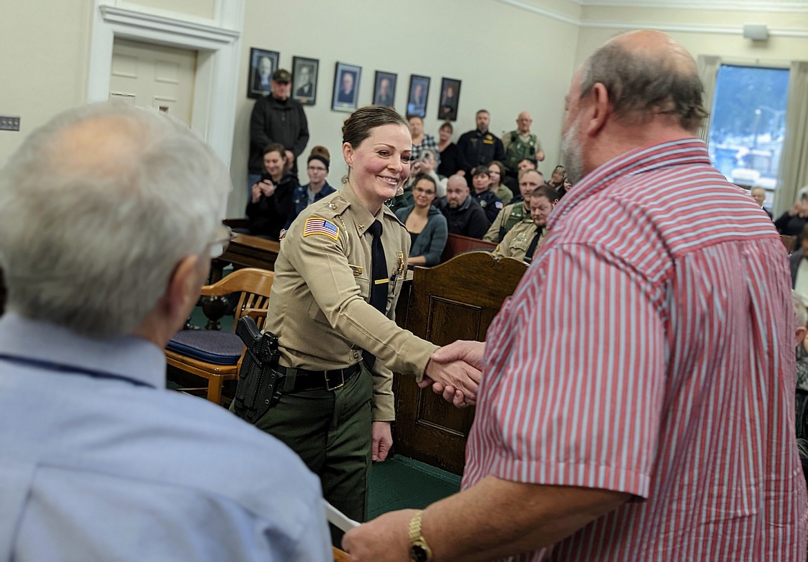 Sheriff Holly Lindsey and Commissioner Jay Huber shake hands after she was sworn in Monday morning at the courthouse in Wallace. Lindsey has served in the role of Undersheriff for the last six years.