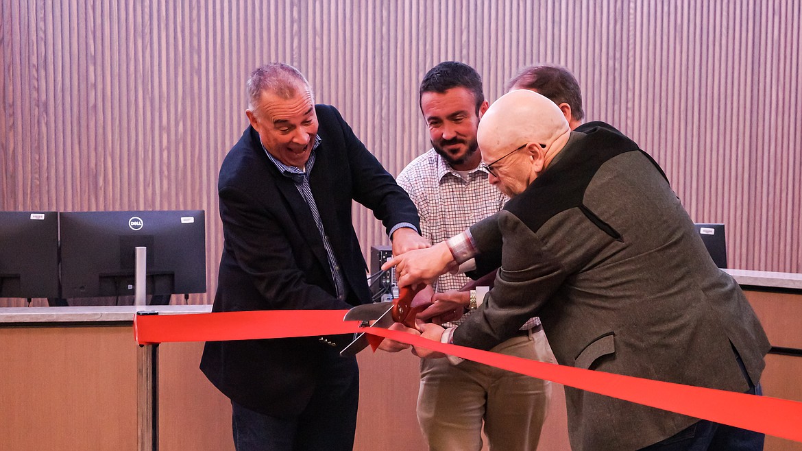 Flathead County officials, including County Commissioner Randy Brodehl, left, Justice Court Judge Paul Sullivan, center, and County Commissioner Brad Abell cut the ribbon on the new Justice Court building on Monday, Dec. 12. The remodeling of the 935 First Ave. W. building, which comes amid a shuffling of county agencies to make room for a fifth judge, cost a little more than $2 million. The dollars come from the county's PILT fund. "They've done a remarkable job," said District Court Judge Dan Wilson. "This is something that Flathead County can be proud of." (Photo courtesy Flathead County)